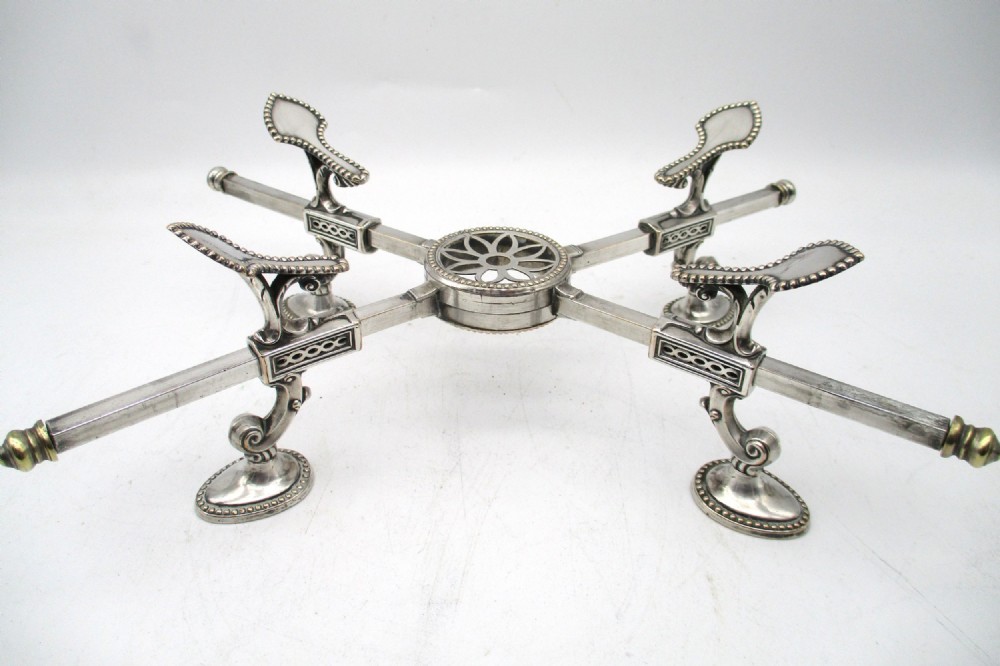 An antique Georgian Sheffield plated silver dish cross featuring four adjustable sliding arms with beaded support pads and feet. View VII