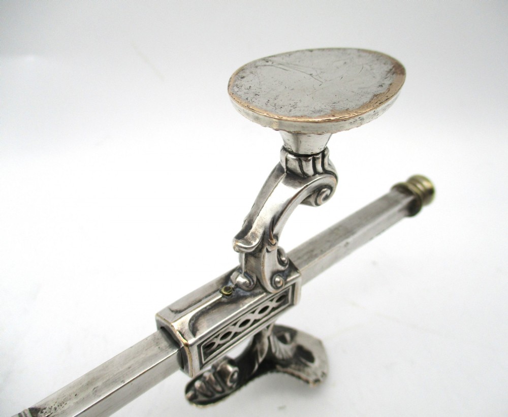 An antique Georgian Sheffield plated silver dish cross featuring four adjustable sliding arms with beaded support pads and feet. View XII