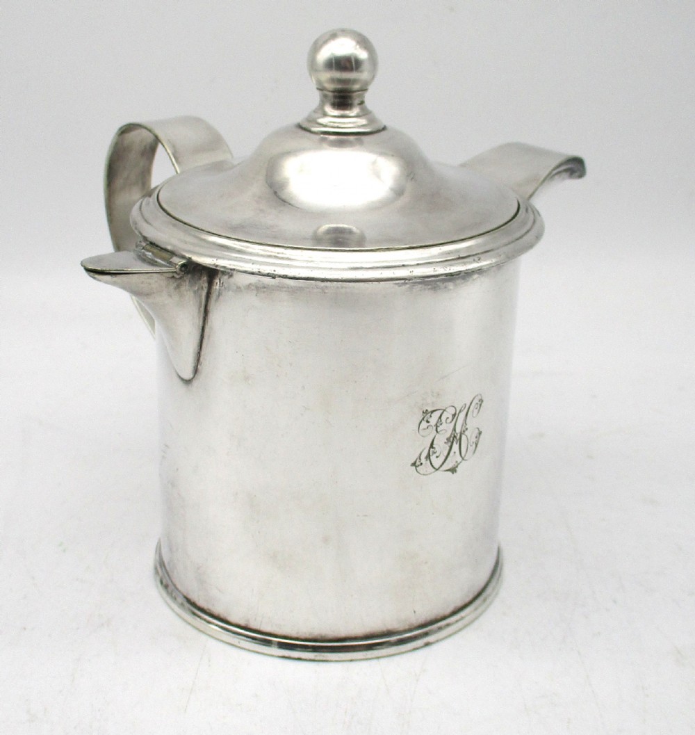A cylindrical mid 19th-century silver-plated argyll gravy warmer with a rounded lid, ball finial, double spout, handle, and engraved cursive monogram. View II