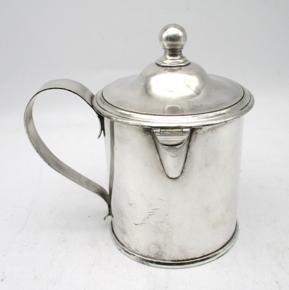 A cylindrical mid 19th-century silver-plated argyll gravy warmer with a rounded lid, ball finial, double spout, handle, and engraved cursive monogram. View III
