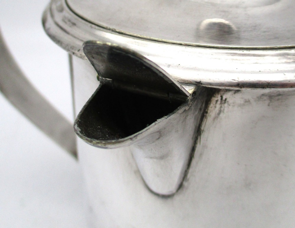 A cylindrical mid 19th-century silver-plated argyll gravy warmer with a rounded lid, ball finial, double spout, handle, and engraved cursive monogram. View V