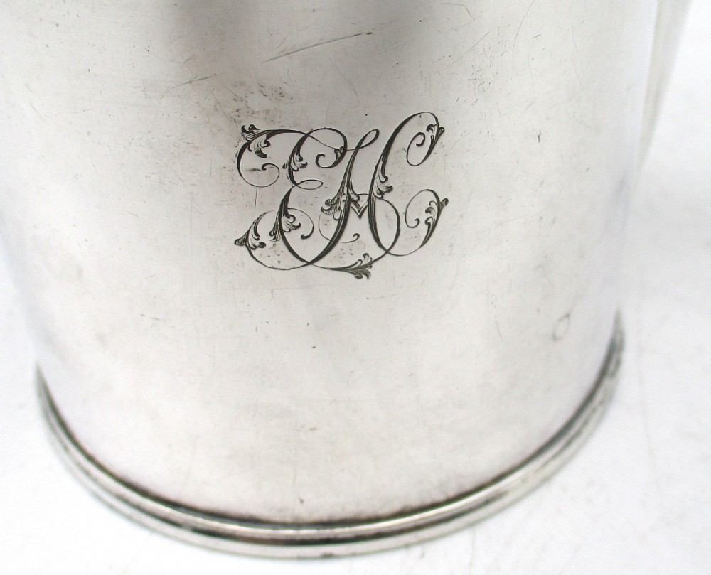 A cylindrical mid 19th-century silver-plated argyll gravy warmer with a rounded lid, ball finial, double spout, handle, and engraved cursive monogram. View VI