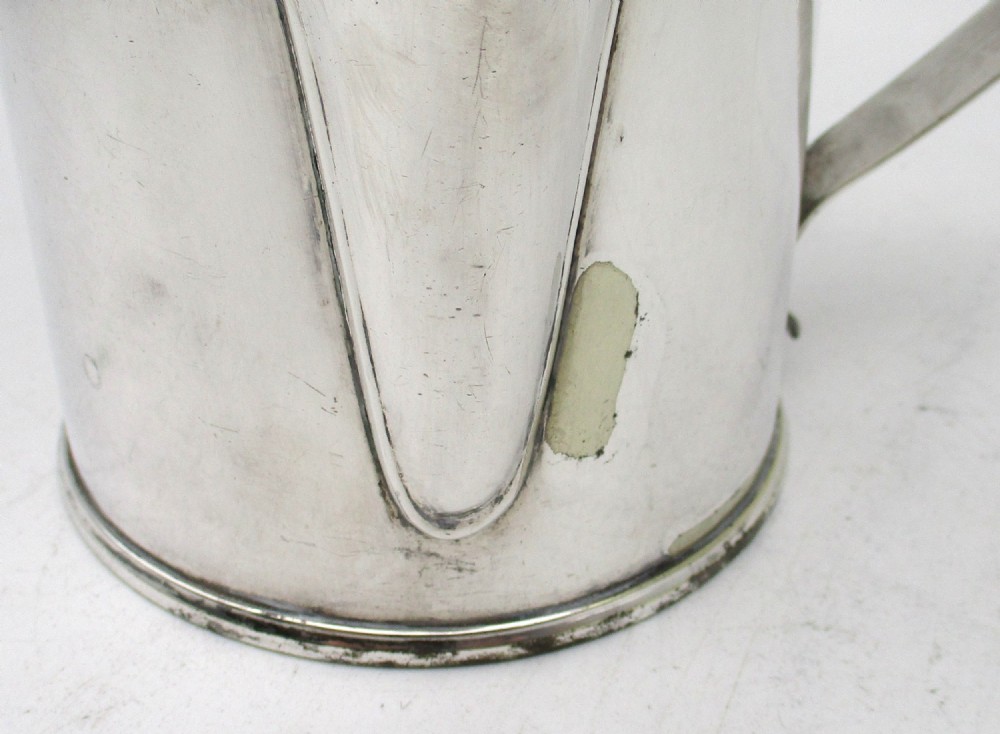 A cylindrical mid 19th-century silver-plated argyll gravy warmer with a rounded lid, ball finial, double spout, handle, and engraved cursive monogram. View VIII