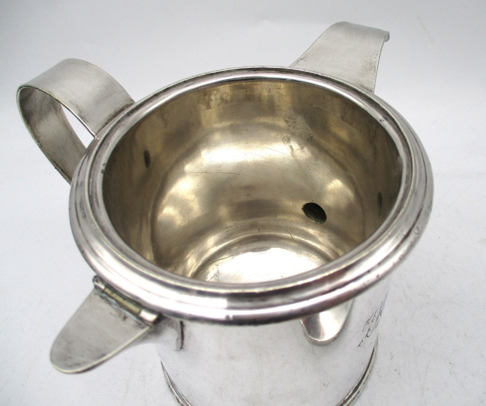 A cylindrical mid 19th-century silver-plated argyll gravy warmer with a rounded lid, ball finial, double spout, handle, and engraved cursive monogram. View IX
