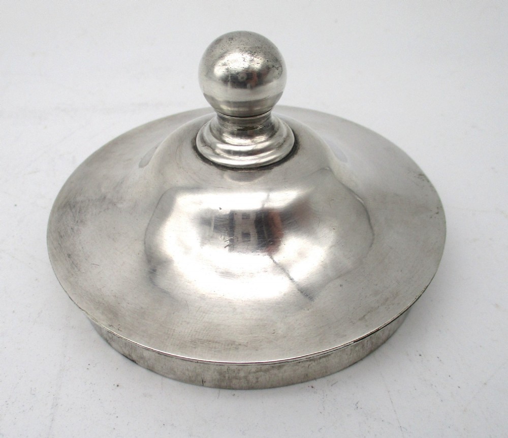 A cylindrical mid 19th-century silver-plated argyll gravy warmer with a rounded lid, ball finial, double spout, handle, and engraved cursive monogram. View X