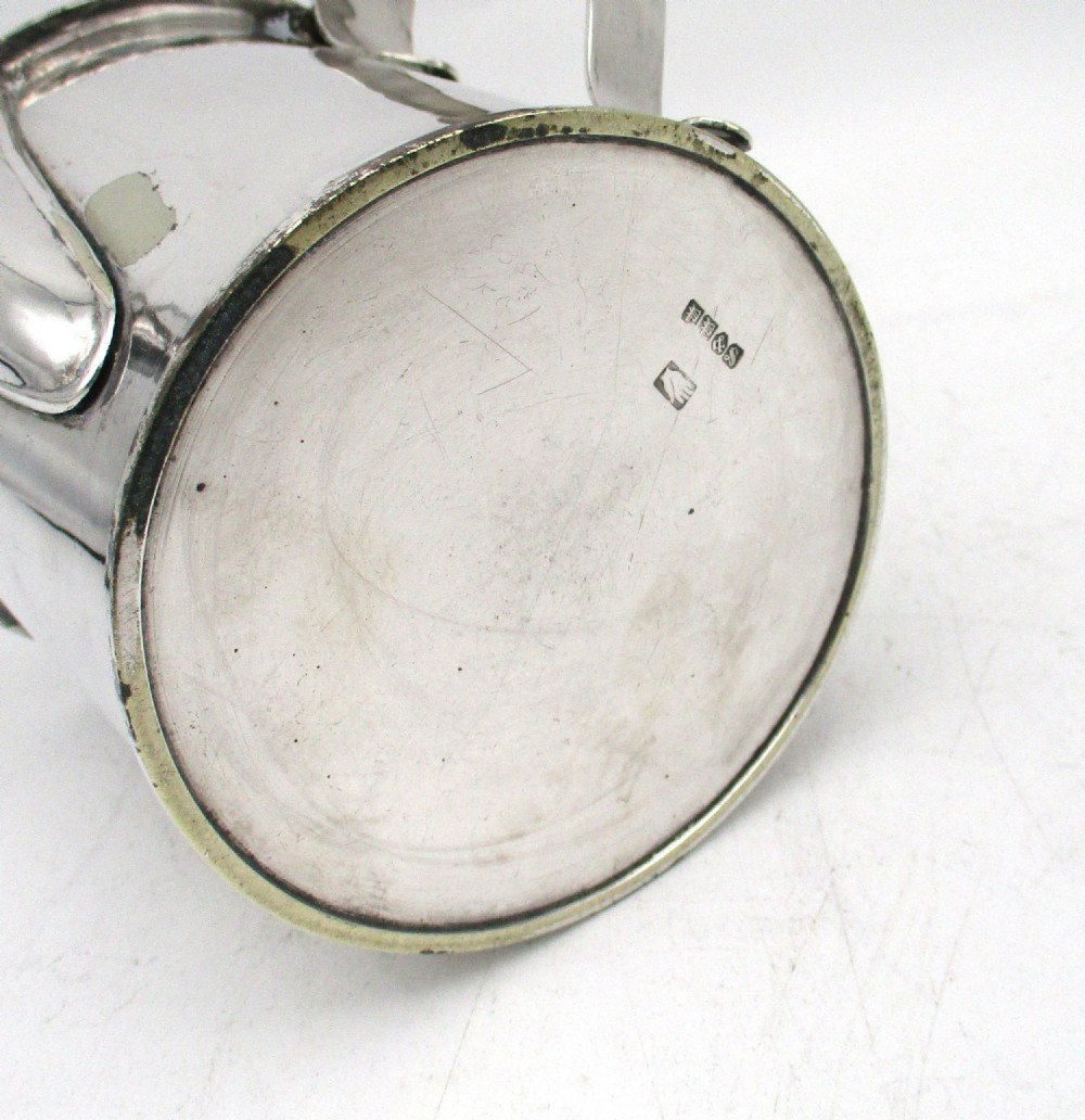 A cylindrical mid 19th-century silver-plated argyll gravy warmer with a rounded lid, ball finial, double spout, handle, and engraved cursive monogram. View XI