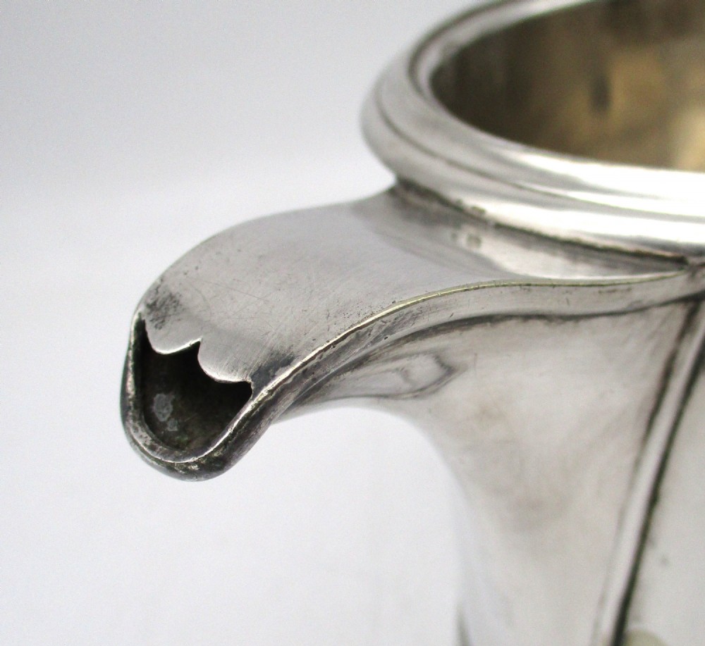 A cylindrical mid 19th-century silver-plated argyll gravy warmer with a rounded lid, ball finial, double spout, handle, and engraved cursive monogram. View XII