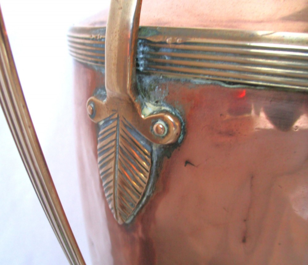 An early nineteenth-century copper tea urn featuring loop handles, a brass spigot, a decorative finial, and a square stepped pedestal base. View IV