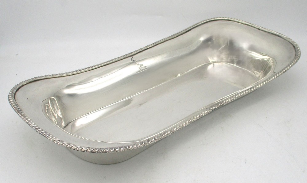 An elongated 19th-century silver-plated knife tray with a gadrooned rope-twist border rim and an engraved motif on the inner wall. View II
