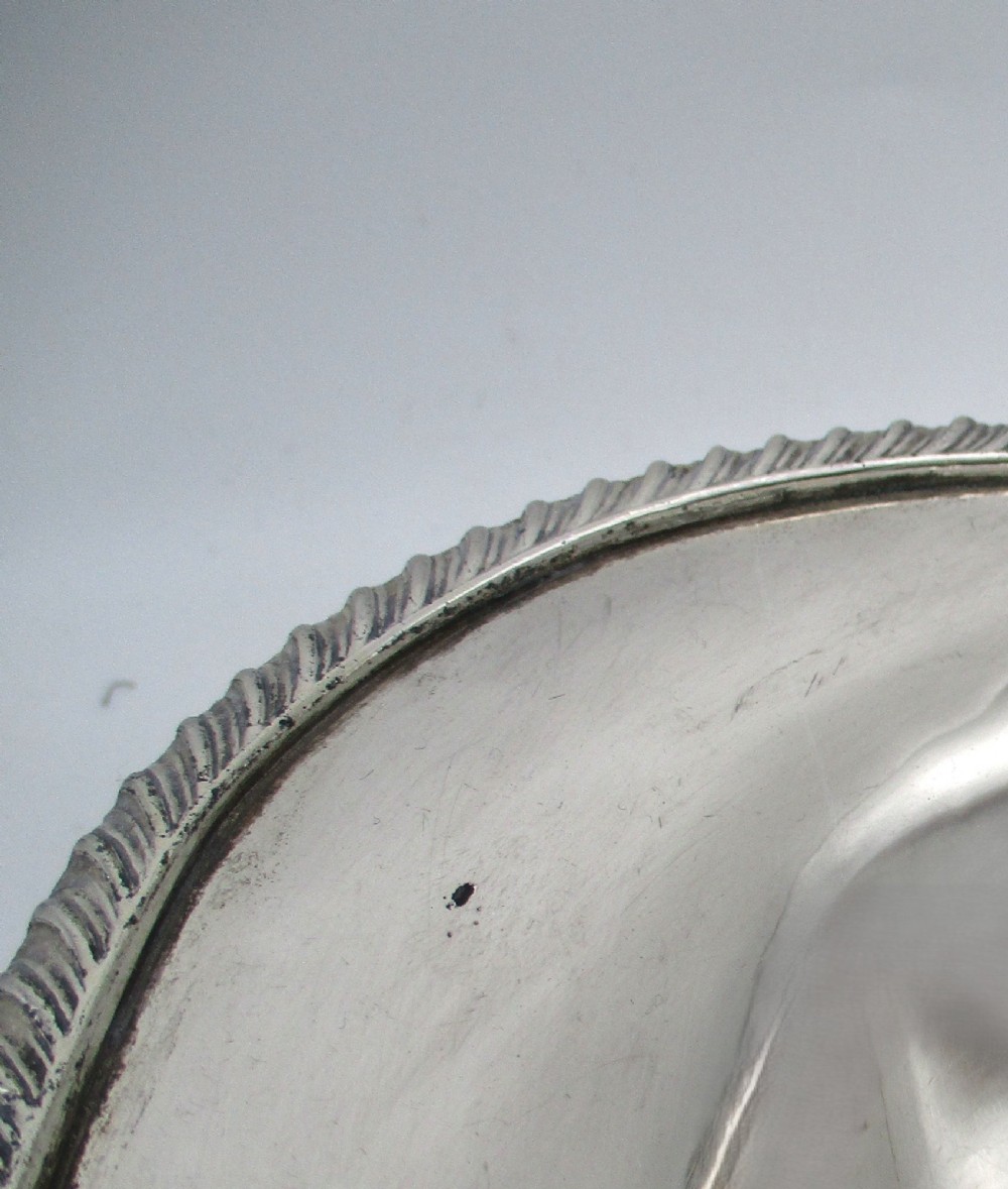 An elongated 19th-century silver-plated knife tray with a gadrooned rope-twist border rim and an engraved motif on the inner wall. View IV