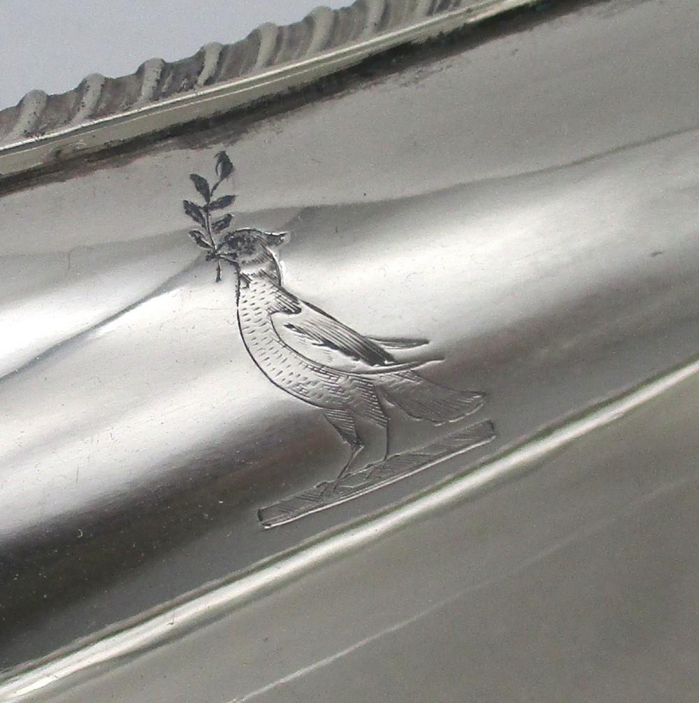 An elongated 19th-century silver-plated knife tray with a gadrooned rope-twist border rim and an engraved motif on the inner wall. View V