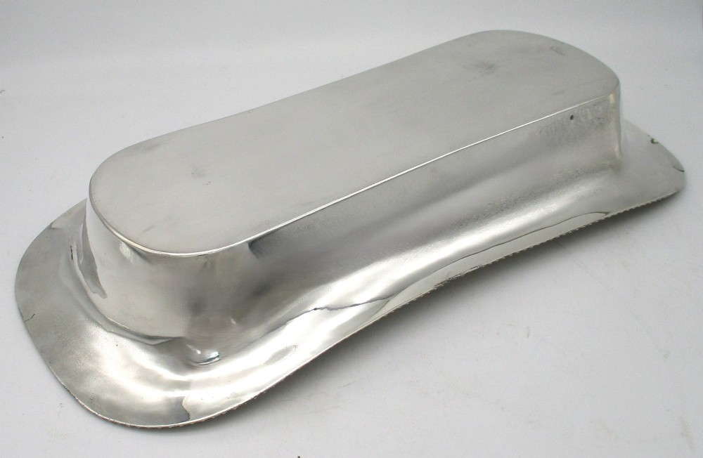 An elongated 19th-century silver-plated knife tray with a gadrooned rope-twist border rim and an engraved motif on the inner wall. View VIII