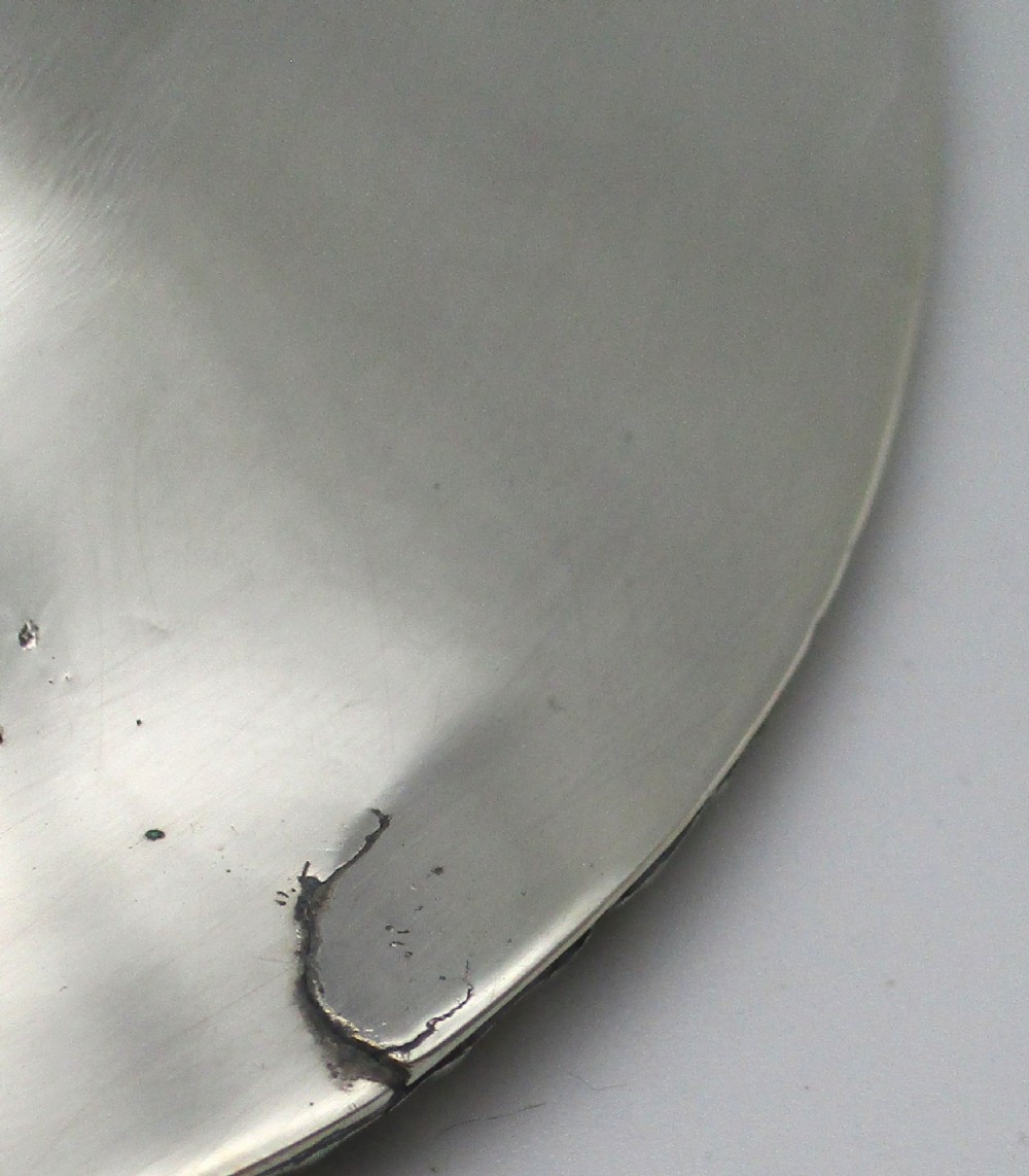 An elongated 19th-century silver-plated knife tray with a gadrooned rope-twist border rim and an engraved motif on the inner wall. View IX