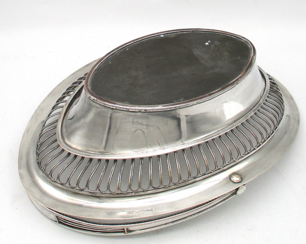 An oval Old Sheffield plate silver basket featuring an openwork wirework gallery, a beaded rim, and an overhead swing handle. View X
