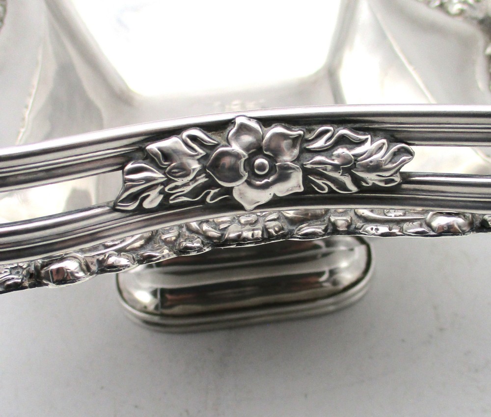 A Regency silver-plated fruit basket featuring a lobed rim with embossed floral motifs and a hinged overhead handle. View VIII