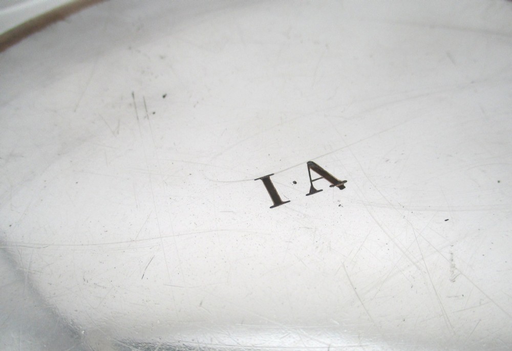 A stack of silver-plated dinner plates displaying scalloped, gadrooned borders with subtle copper show-through along the inner rims. View VII