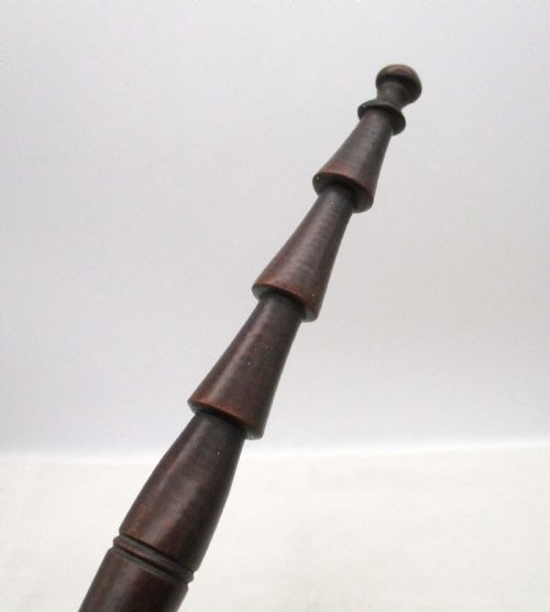 A Georgian turned dark mahogany fire cat featuring six radiating spoked arms attached to a central turned baluster hub. View VI