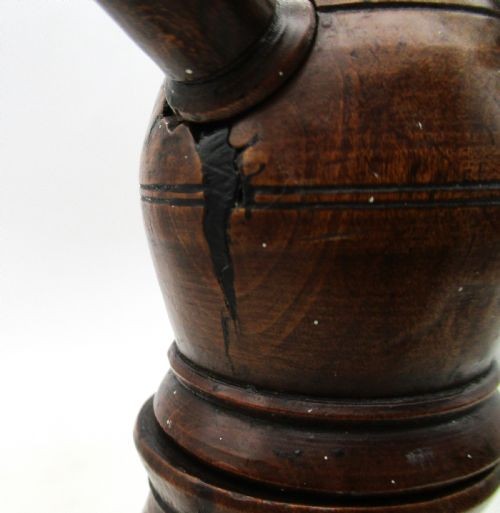 A Georgian turned dark mahogany fire cat featuring six radiating spoked arms attached to a central turned baluster hub. View VIII