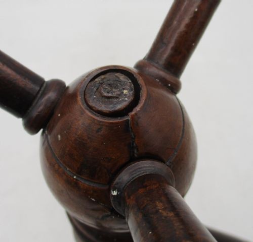 A Georgian turned dark mahogany fire cat featuring six radiating spoked arms attached to a central turned baluster hub. View IX