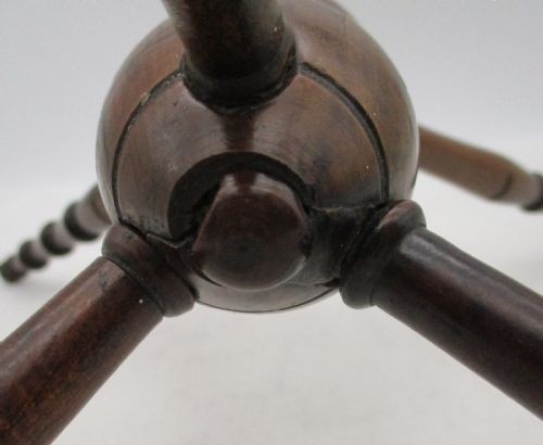 A Georgian turned dark mahogany fire cat featuring six radiating spoked arms attached to a central turned baluster hub. View X