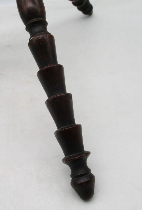 An antique Georgian dark mahogany wooden fire cat featuring six turned spindle limbs connected to a central turned joint. View III
