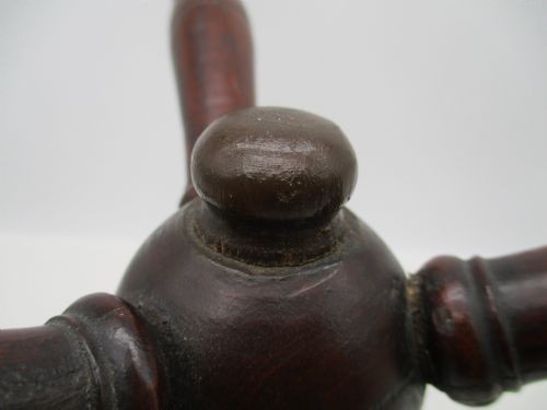 An antique Georgian dark mahogany wooden fire cat featuring six turned spindle limbs connected to a central turned joint. View V