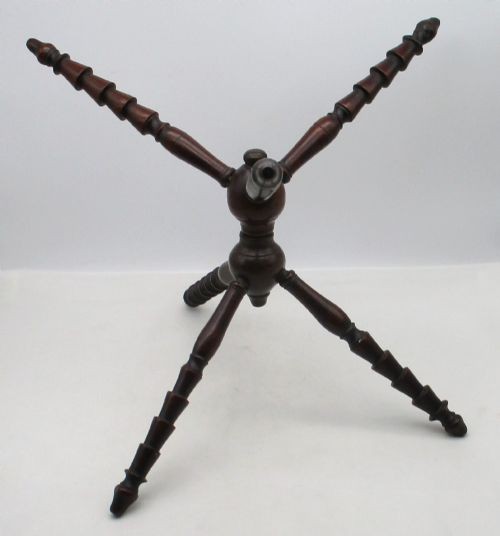 An antique Georgian dark mahogany wooden fire cat featuring six turned spindle limbs connected to a central turned joint. View VII