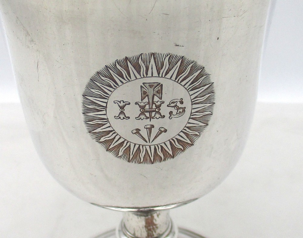 A 19th-century silver-plated church chalice featuring a flared cup with an engraved IHS Christogram medallion, a knopped stem, and a stepped circular base. View III
