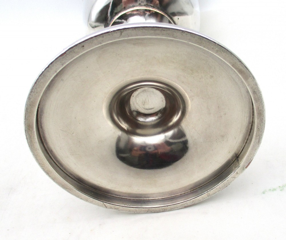 A 19th-century silver-plated church chalice featuring a flared cup with an engraved IHS Christogram medallion, a knopped stem, and a stepped circular base. View VIII