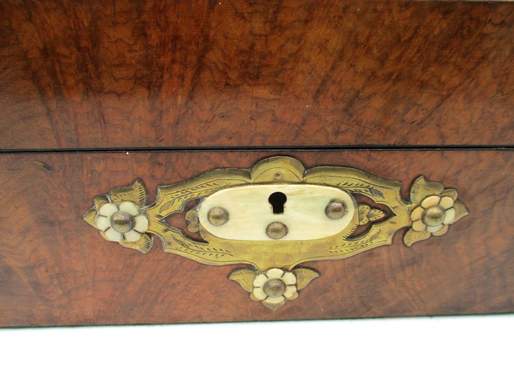 A rectangular warm brown wooden jewellery box decorated with polished brass corner mounts, bone inlays, and side carrying handles. View III