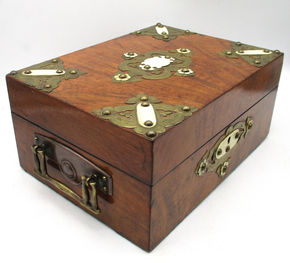 A rectangular warm brown wooden jewellery box decorated with polished brass corner mounts, bone inlays, and side carrying handles. View IV