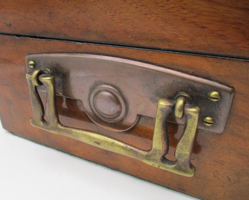 A rectangular warm brown wooden jewellery box decorated with polished brass corner mounts, bone inlays, and side carrying handles. View V
