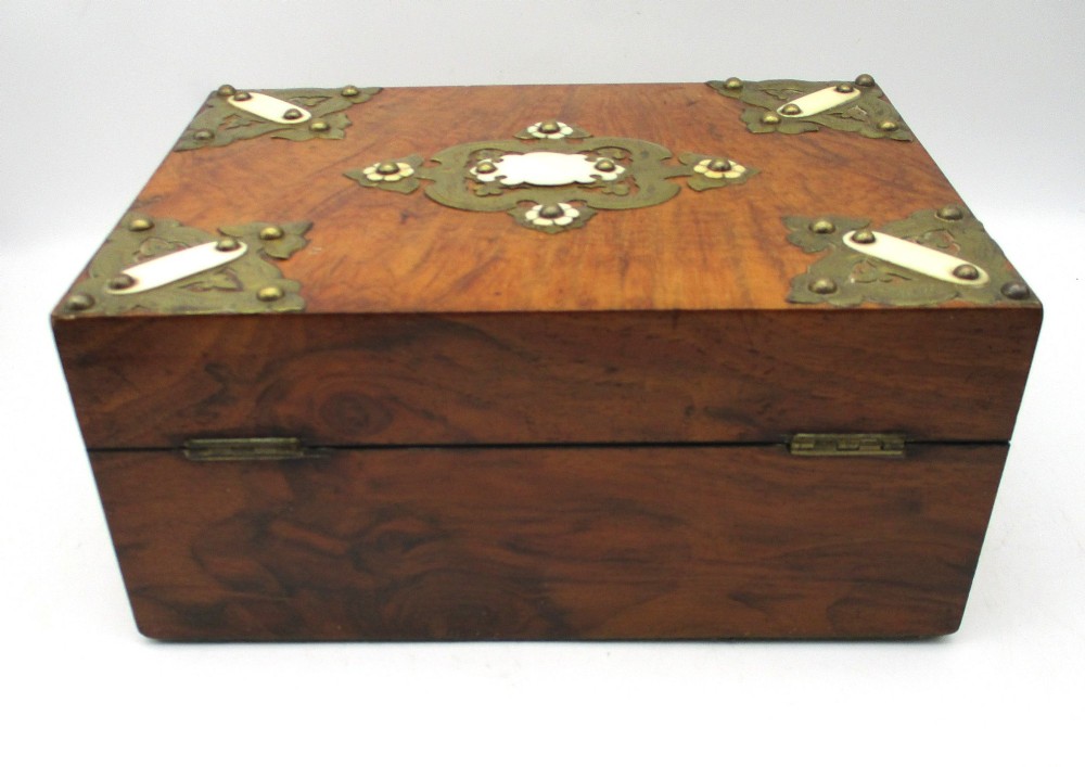 A rectangular warm brown wooden jewellery box decorated with polished brass corner mounts, bone inlays, and side carrying handles. View VII