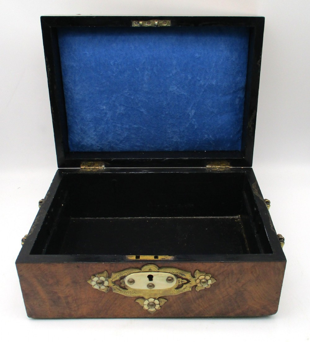 A rectangular warm brown wooden jewellery box decorated with polished brass corner mounts, bone inlays, and side carrying handles. View VIII