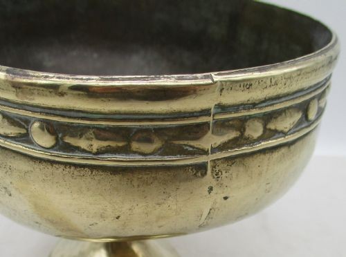 A pair of oval brass pedestal bowls with stamped geometric rim borders and turned flared bases. View VIII