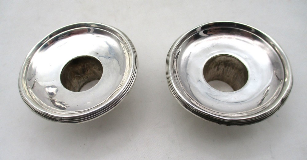 A pair of 19th-century silver-plated candlesticks featuring fluted tapered stems, urn-form sconces, and circular stepped bases. View III