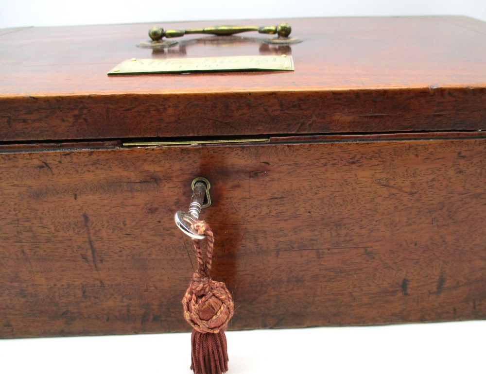 A rectangular mid-18th-century mahogany document box featuring a top brass swing handle, an engraved brass nameplate, and a brass keyhole escutcheon. View V