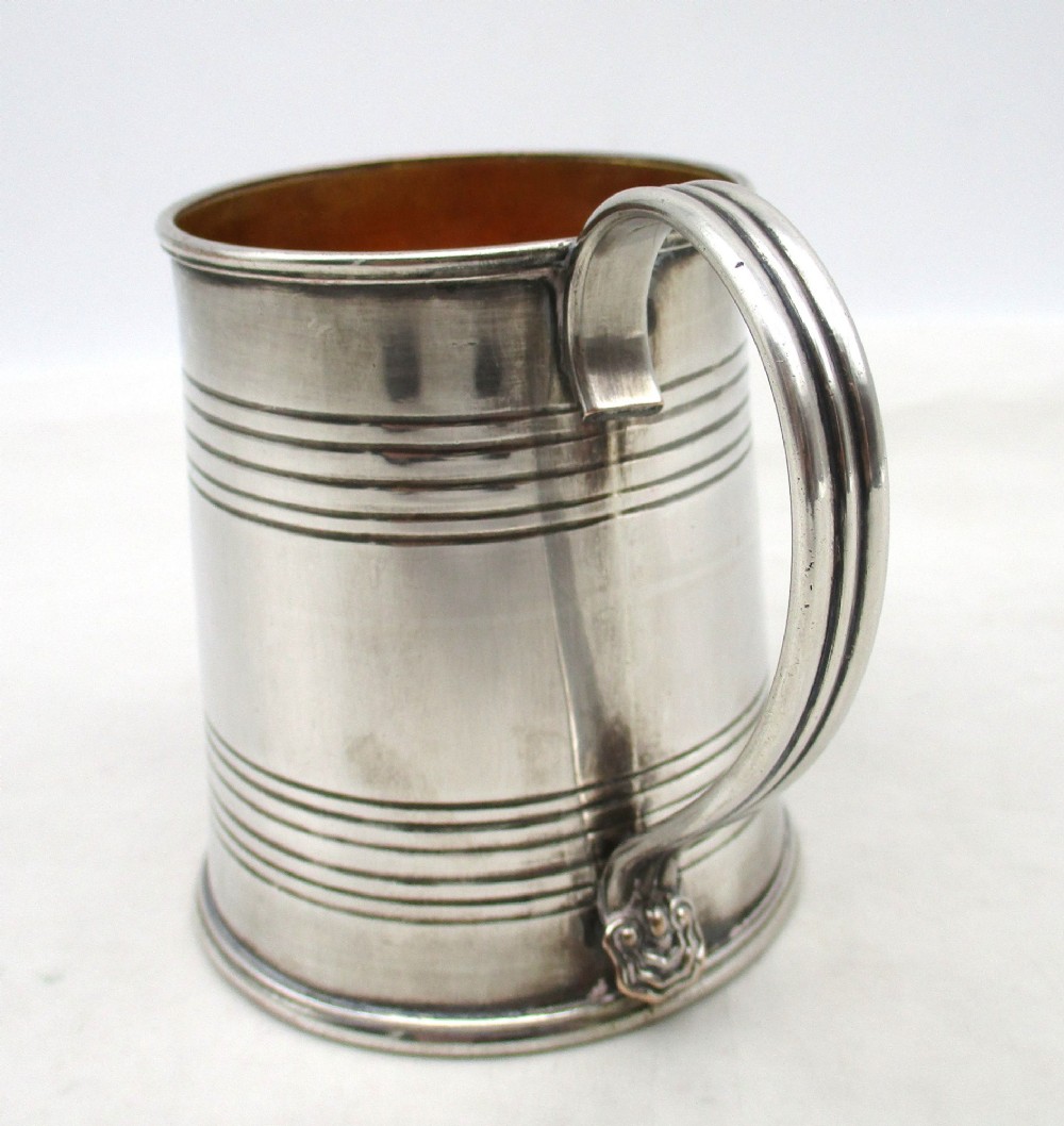 A Regency period Old Sheffield Plate childs tankard featuring horizontal reeded banding, a curved handle, and a gilt-lined interior. View III