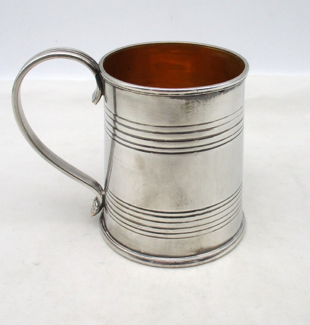A Regency period Old Sheffield Plate childs tankard featuring horizontal reeded banding, a curved handle, and a gilt-lined interior. View IV
