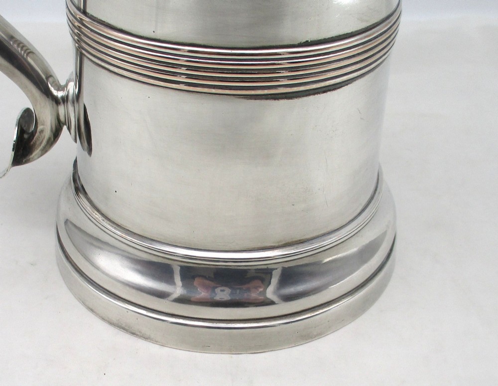 A Georgian Old Sheffield plated silver tankard featuring a reeded central band, a curved handle, and a stepped circular base. View III