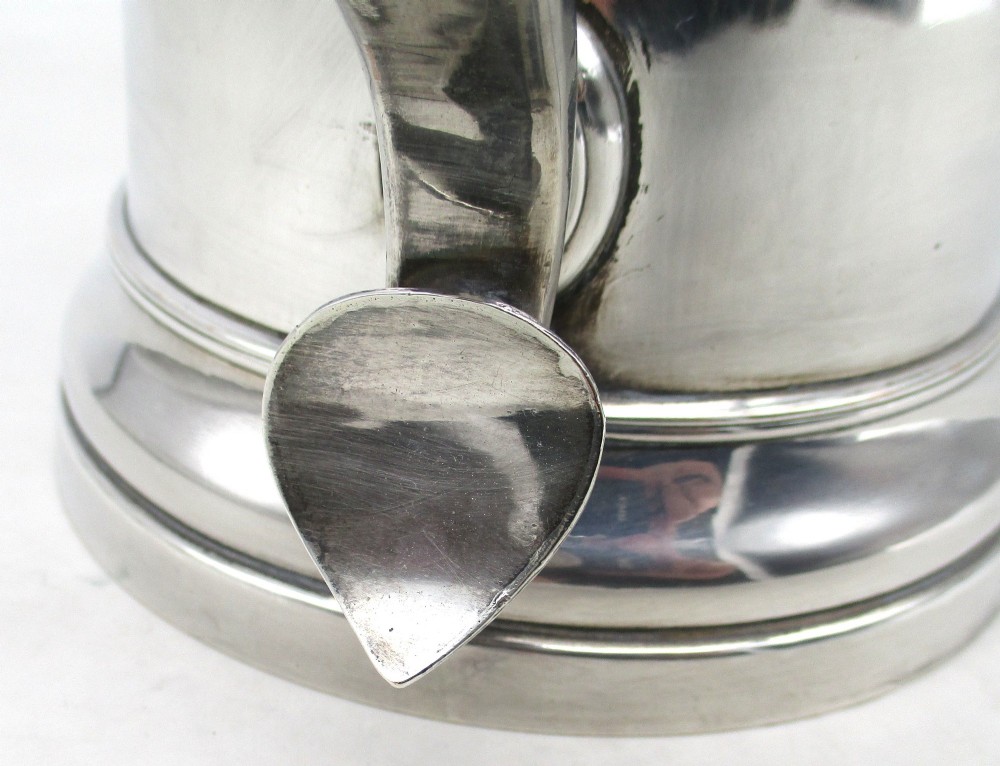 A Georgian Old Sheffield plated silver tankard featuring a reeded central band, a curved handle, and a stepped circular base. View VII