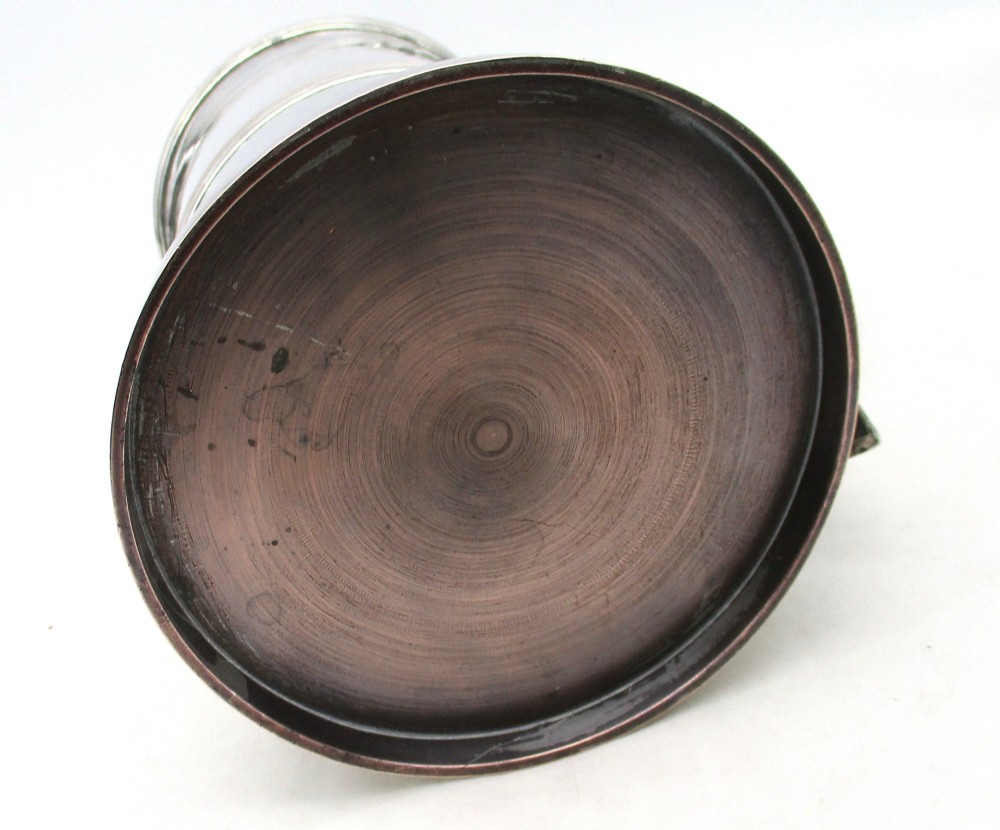 A Georgian Old Sheffield plated silver tankard featuring a reeded central band, a curved handle, and a stepped circular base. View X