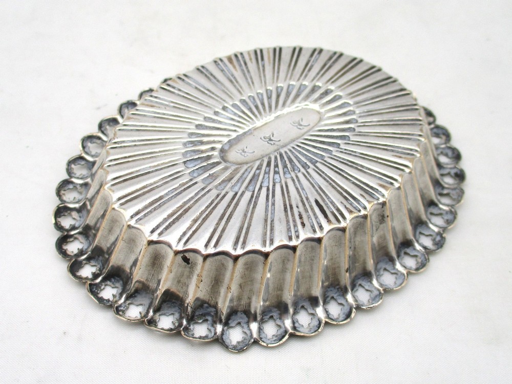 An 18th-century oval Old Sheffield Plated pin tray featuring fluted radiating panels, a smooth central oval, and a pierced scalloped rim. View IV