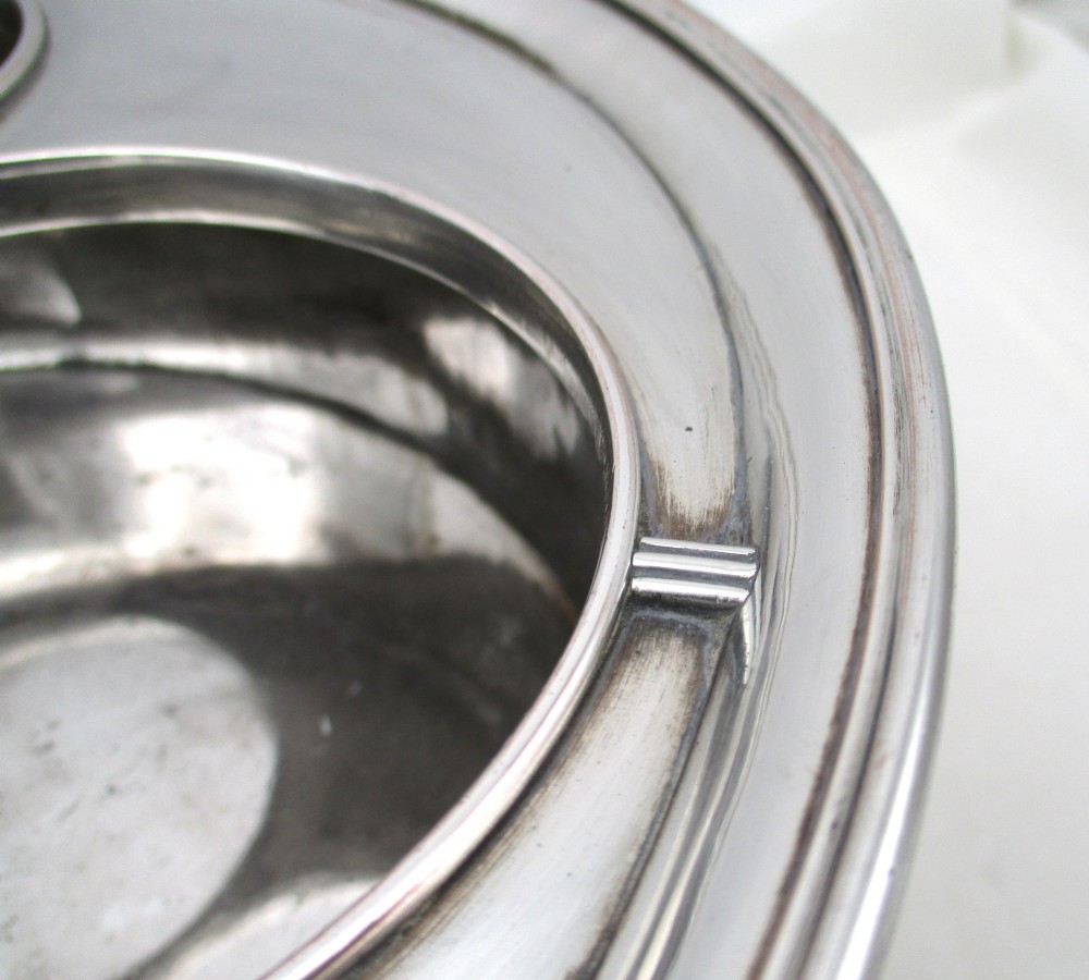An oval Georgian silver-plated wine cooler designed to hold three bottles with a central finial handle. View VI