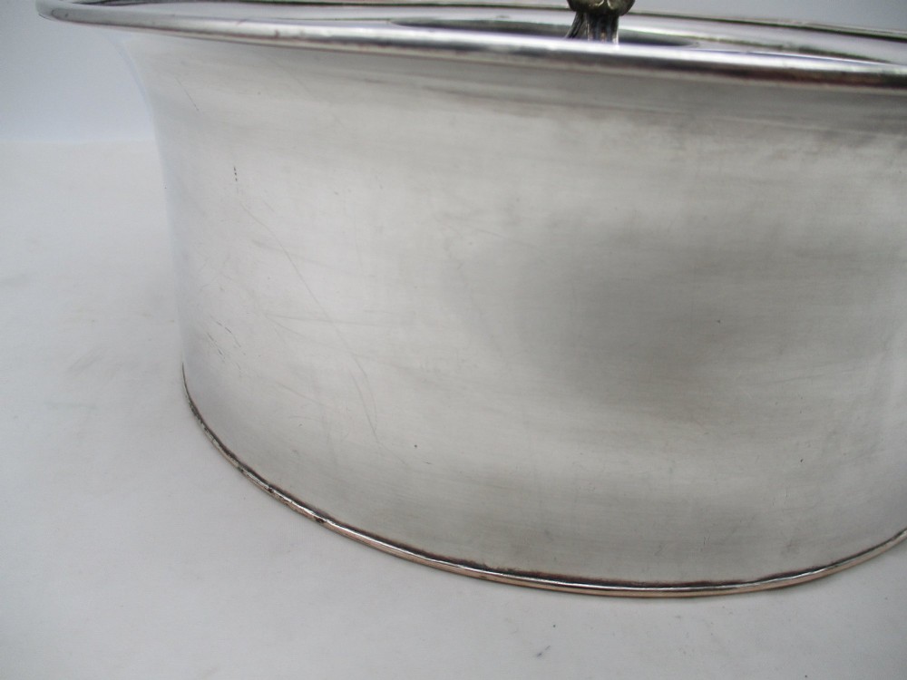 An oval Georgian silver-plated wine cooler designed to hold three bottles with a central finial handle. View VII
