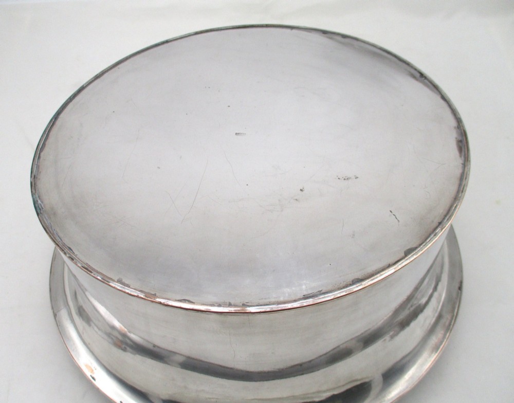 An oval Georgian silver-plated wine cooler designed to hold three bottles with a central finial handle. View VIII