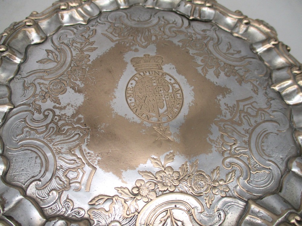 A pair of circular 18th-century Old Sheffield plated card trays with shell borders, heraldic crest engravings, and small scroll feet. View III
