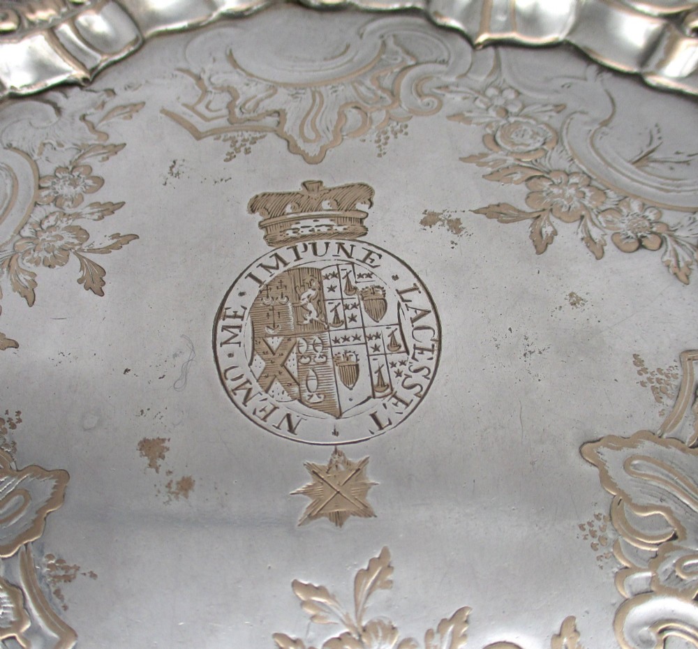 A pair of circular 18th-century Old Sheffield plated card trays with shell borders, heraldic crest engravings, and small scroll feet. View IV
