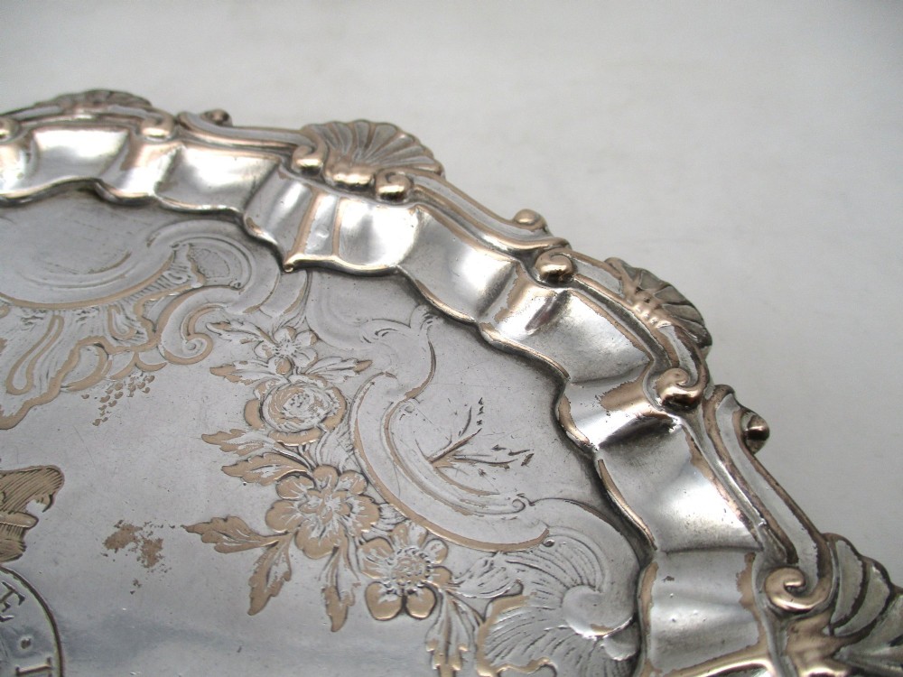 A pair of circular 18th-century Old Sheffield plated card trays with shell borders, heraldic crest engravings, and small scroll feet. View VI