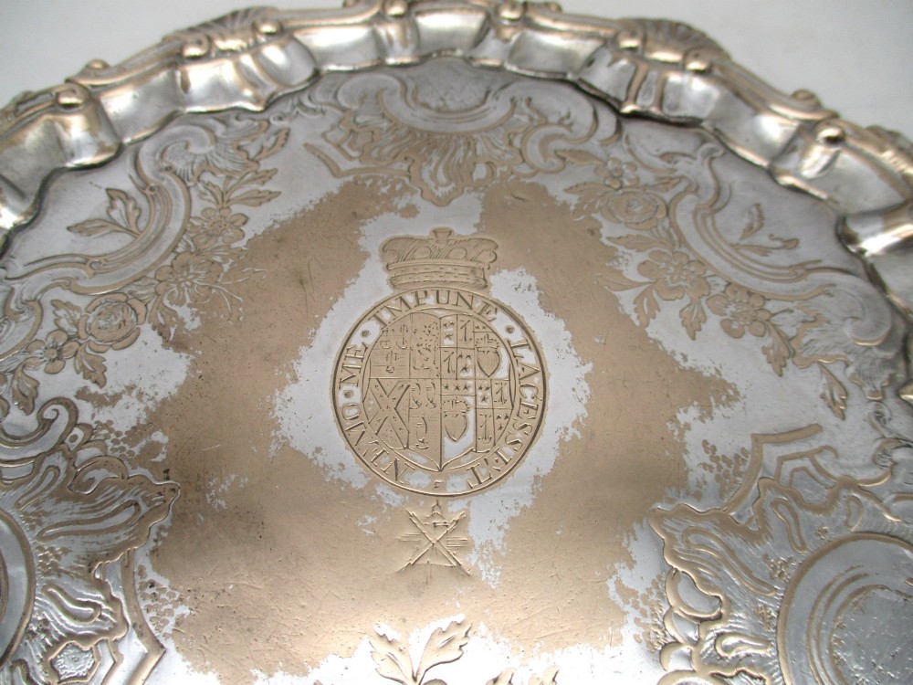A pair of circular 18th-century Old Sheffield plated card trays with shell borders, heraldic crest engravings, and small scroll feet. View VIII